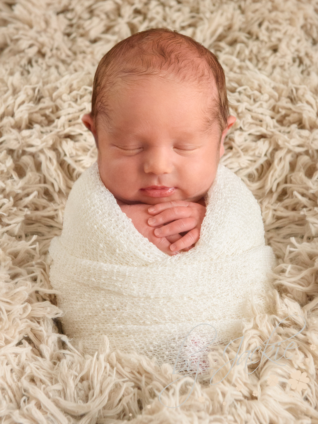 Photograph of newborn baby boy wrapped in potato sack pose by Babies By Jackie, near York, Yorkshire UK