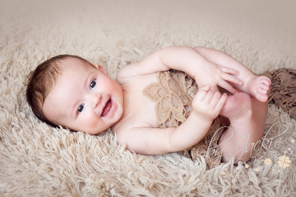 Giggling 4 month old baby girl by Babies By Jackie near York