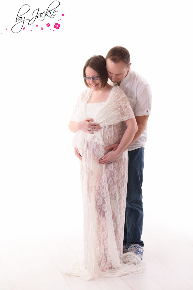 husband and wife posing for maternity photograph. Image by Babies By Jackie near York, Yorkshire UK