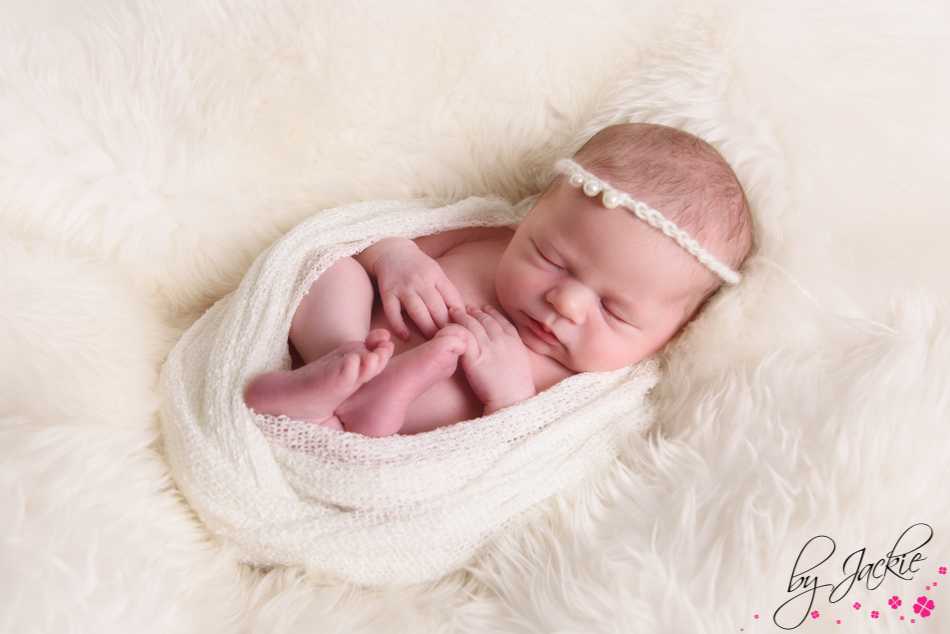 newborn baby girl swaddled in cream. photo by Babies By Jackie near Selby