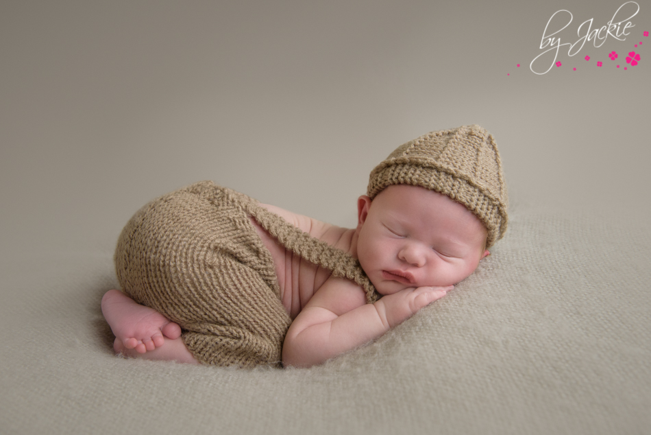 newborn photo of baby by with hat and pants set by jackie photography near york uk