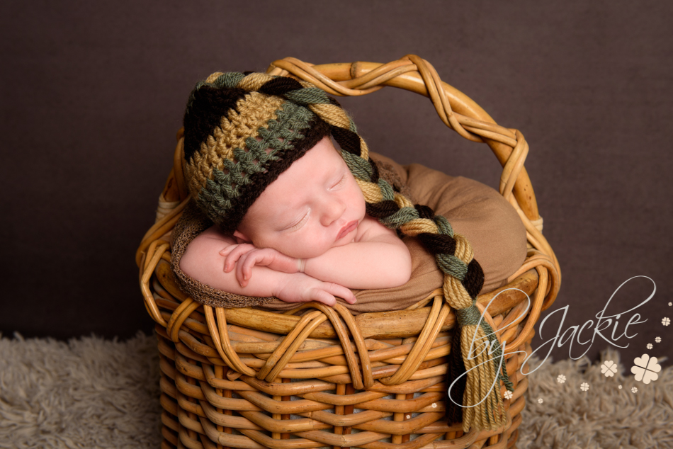 Photograph of newborn baby boy asleep in a basket. Image by Babies By Jackie in Market Weighton, near Beverley, Pocklington and York.