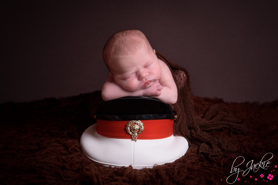baby girl asleep in daddys military hat by Babies By Jackie