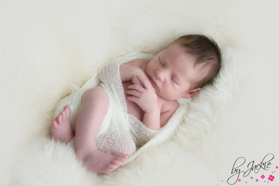 Image of a sleepy newborn baby, swaddled and snoozing near York Photo credit Babies By Jackie