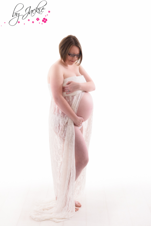 Mum to be posing for maternity photograph in a studio. Babies By Jackie, York, UK