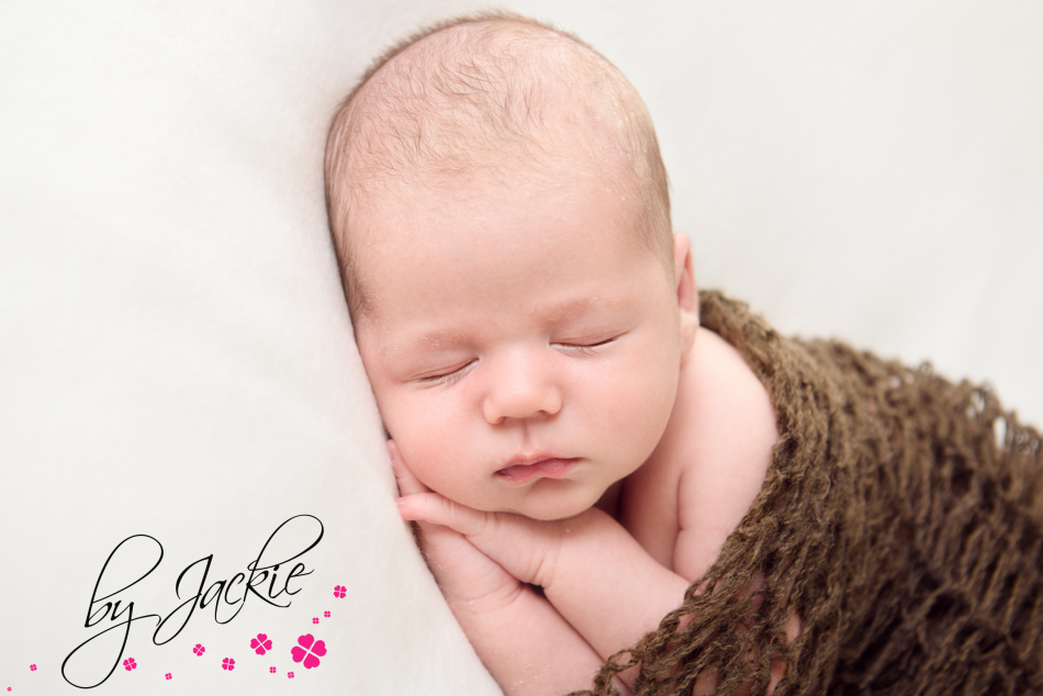 Newborn baby boy snuggled in mohair wrap By Jackie Photography Howden York and Leeds UK