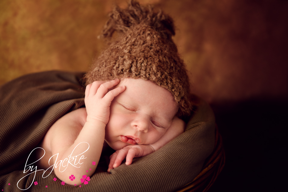 Newborn baby boy with hat in a basket by Babies By Jackie Photography near York, Malton and Pocklington