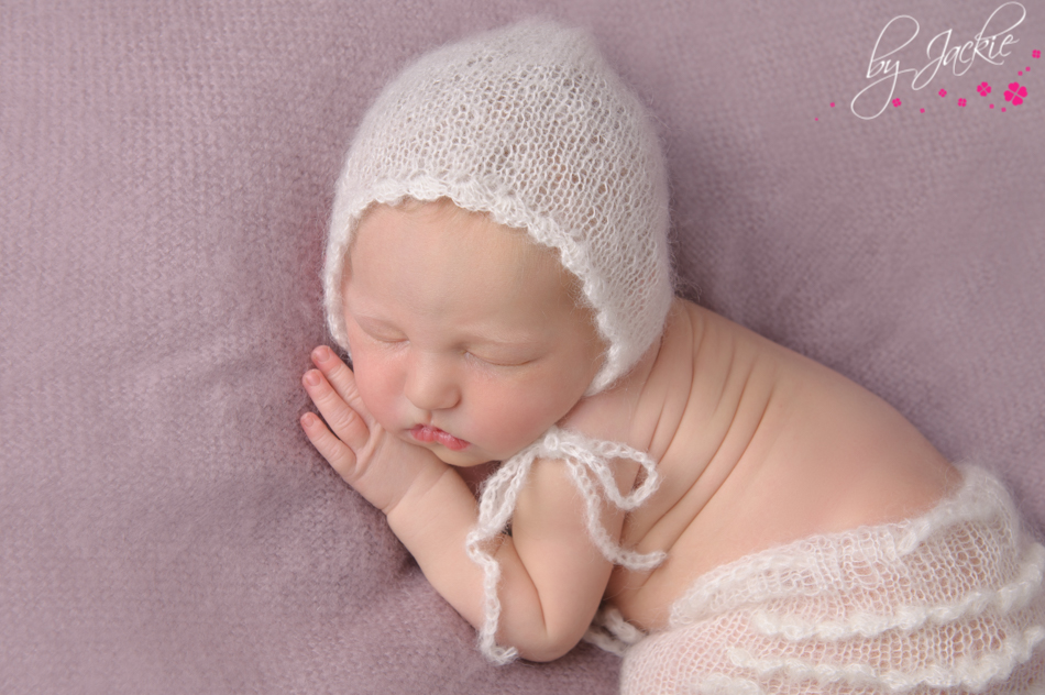 Photo of newborn baby girl in mohair bonnet and frilly pants. Image: Babies By Jackie, York, Yorkshire, UK