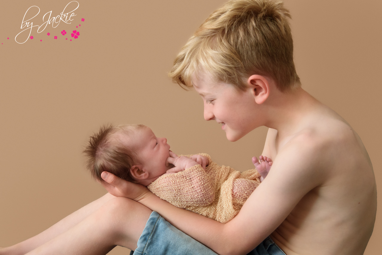 Image of young boy with his newborn baby sister near York By Jackie Photography