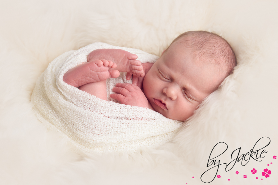 Image of newborn baby wrapped in cream by Babies By Jackie, Howden, York and Leeds