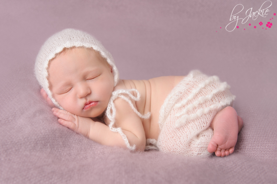 Photo of newborn baby girl in ivory mohair bonnet and frilly pants. Image: Babies By Jackie, York, Yorkshire, UK