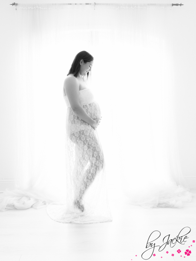 Black and white image of at mum-to-be in front of window at maternity shoot at Step Up Studio Howden Babies By Jackie