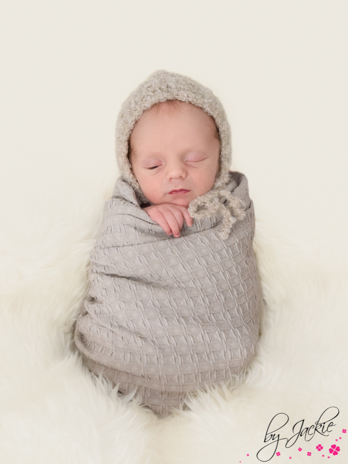 Photo of a newborn baby boy in potato sack pose, eyes peeping! Babies By Jackie near York, Yorkshire