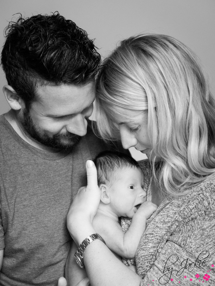 black and white family image of mummy and daddy with their newborn baby boy near Whitby Photo credit Babies By Jackie in North Yorkshire