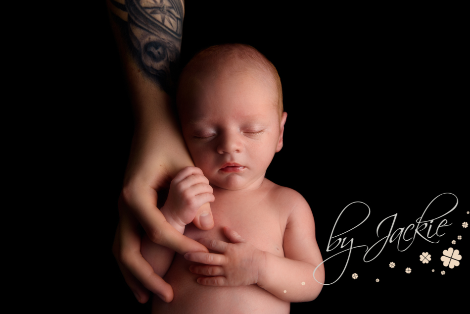 Newborn baby holding his daddy's thumb. Photograph by Babies by Jackie near York, North Yorkshire and Hull, East Ridings of Yorkshire, UK