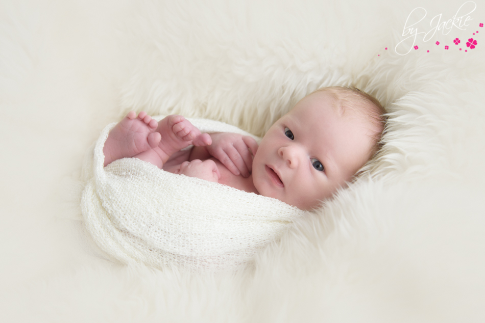 eyes open newborn baby boy sneaking a peek in his first photosession by jackie uk york