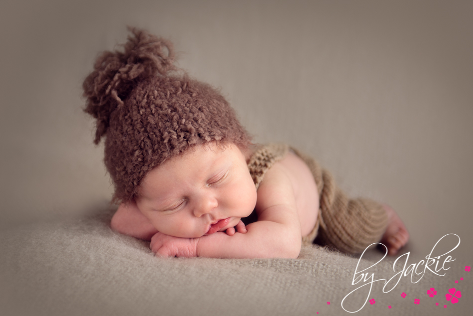 Photography of newborn baby boy in bobble hat. Image by Babies By Jackie, near York, Howden, Goole and East Ridings